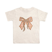 Natural Heather T-shirt with a cinnamon plaid bow patch featuring pearl accents.