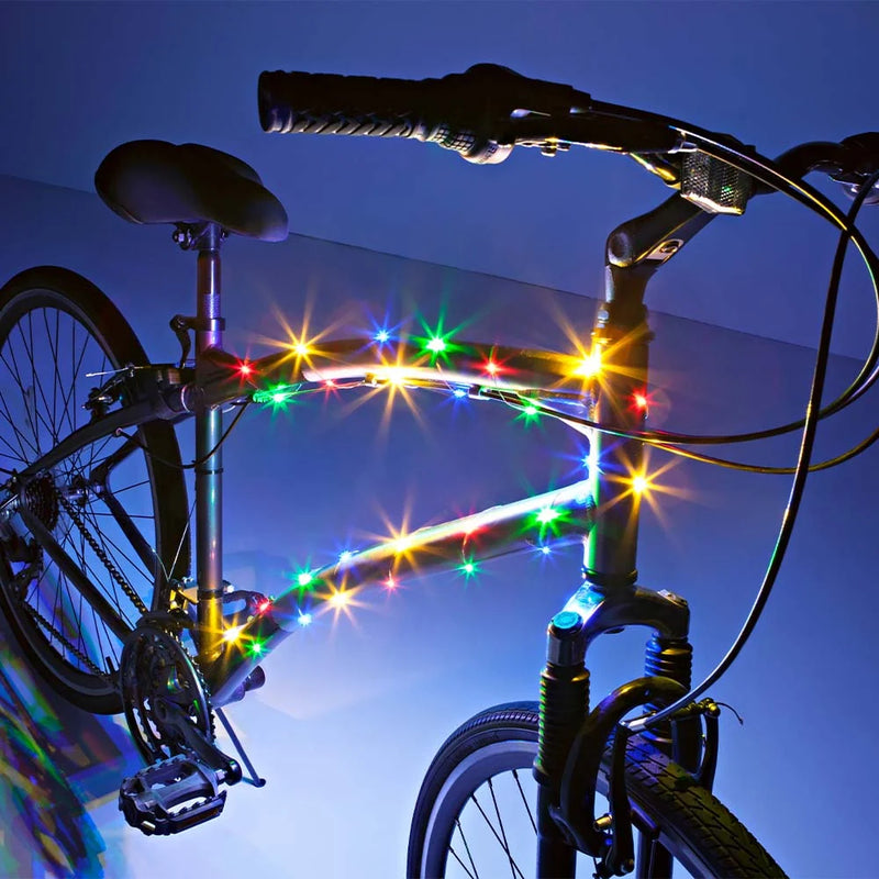 Bike with multicolor LED lights wrapped around the frame, illuminating in a dark setting.