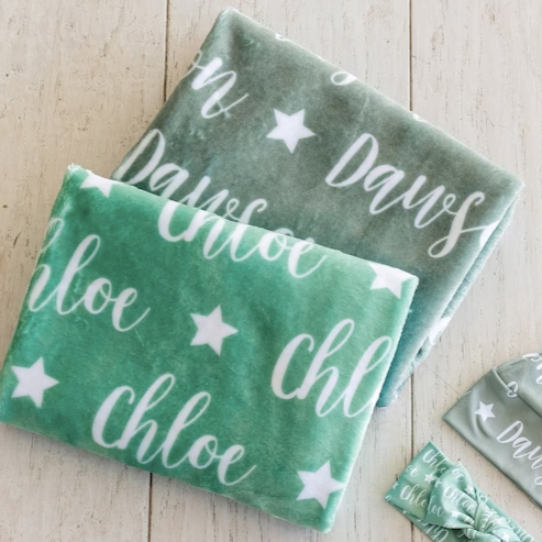 2 blankets, a hat, and a bow with the names chloe and dawson and a star icon
