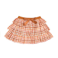 A plaid tiered tutu skirt in blush, cream, and caramel with a burnt orange waistband and satin bow.
