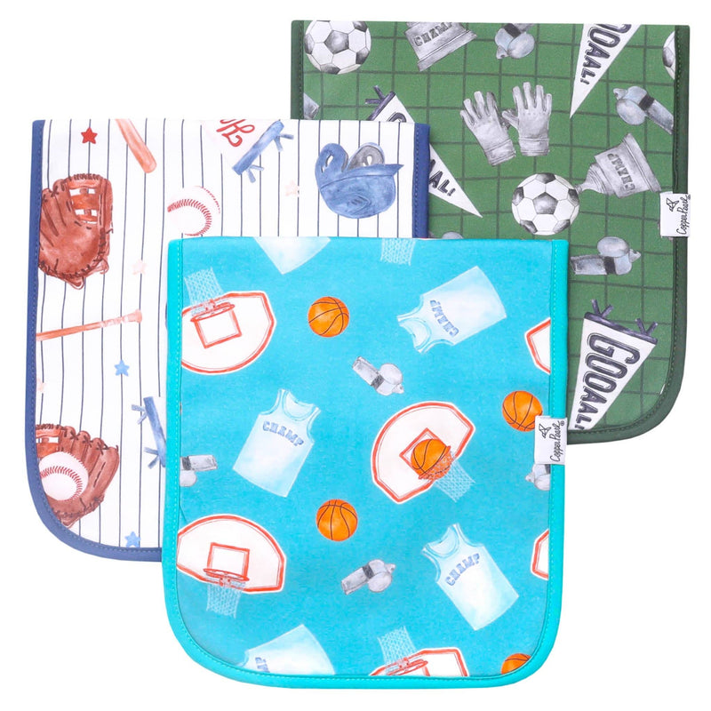 Three reusable cloth baby wipes or hand wipes stacked together on a white background. The top wipe has a green floral pattern, the middle wipe has a white pattern with red and blue illustrations, and the bottom wipe is bright blue with orange and white illustrations.